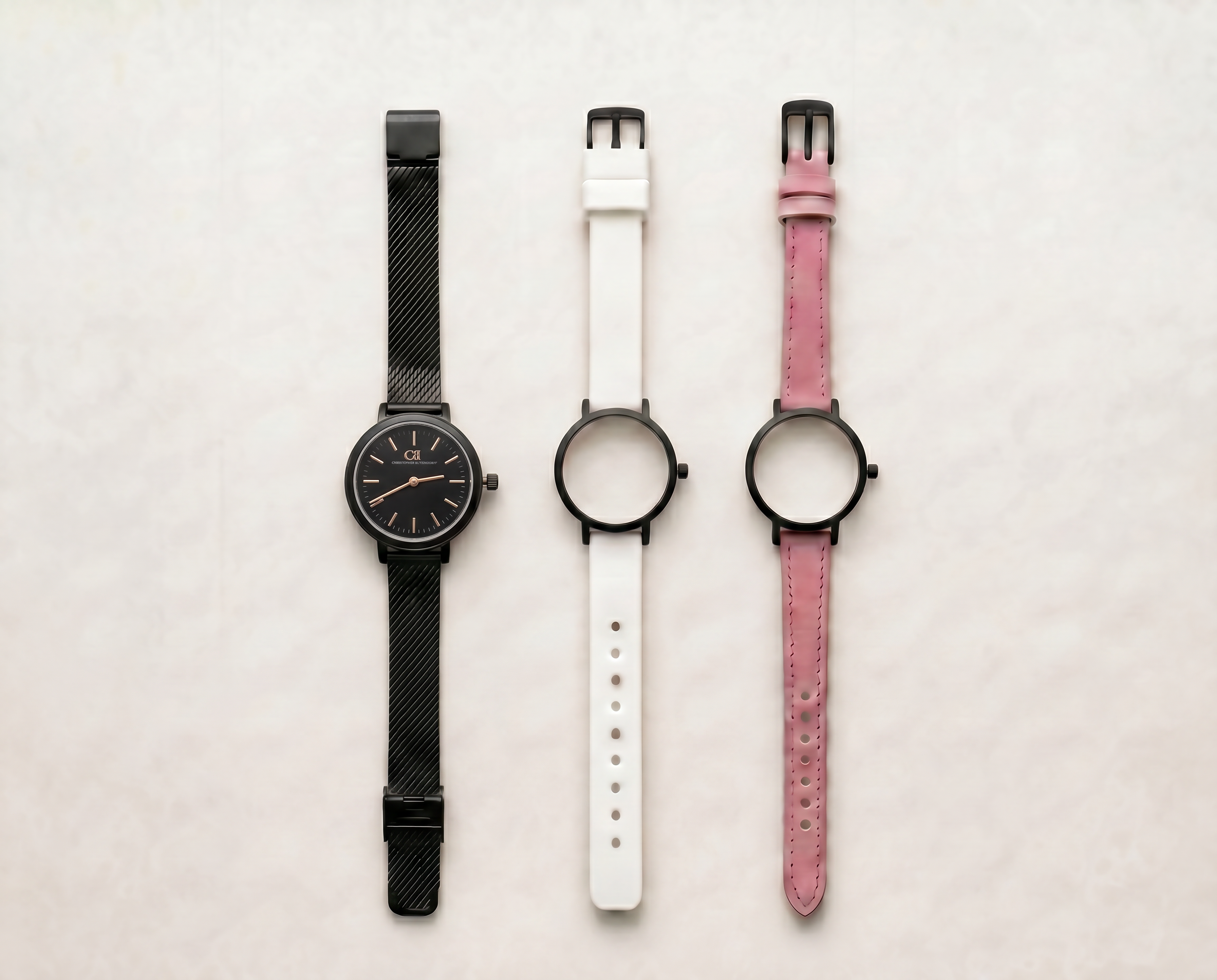 Mixta Swiss Made modular women's watch — round black case with black dial, shown with interchangeable black mesh, white PVC and pink leather straps