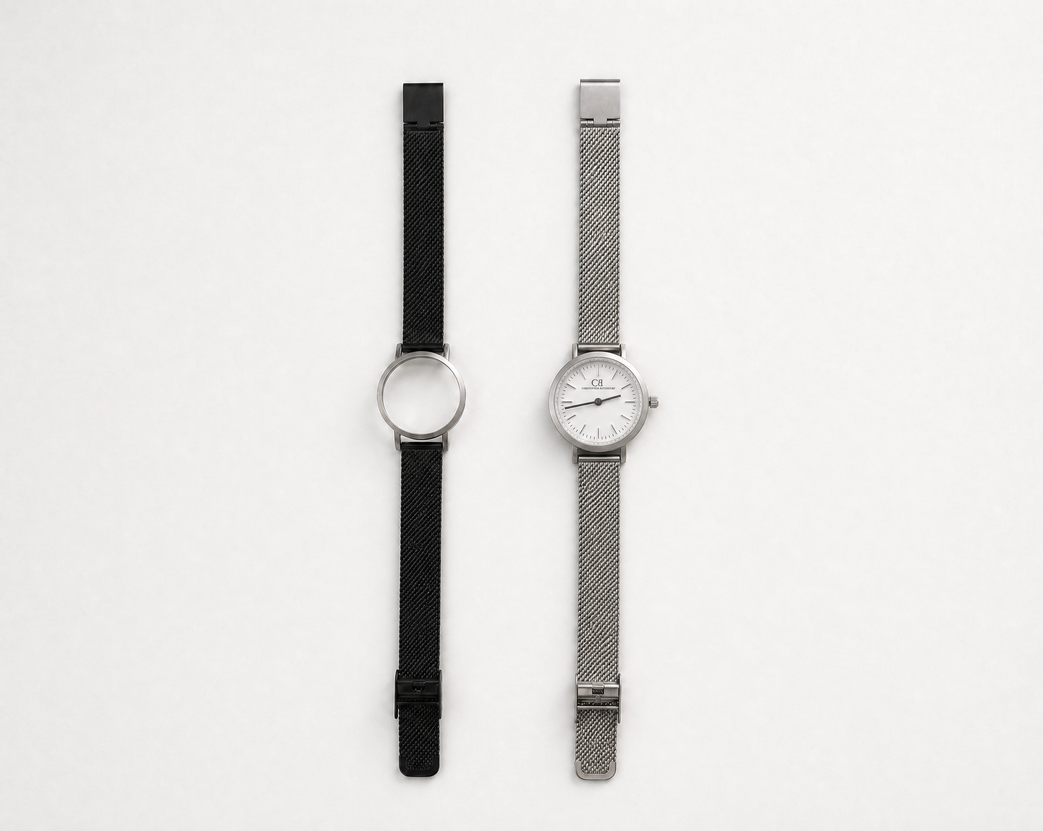 Aureum Swiss Made modular watch — round silver case with white dial and silver mesh strap, shown alongside black case with black mesh strap