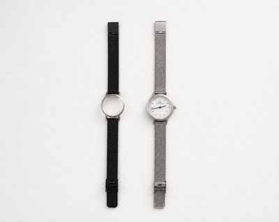 Aureum Swiss Made modular watch — round silver case with white dial and silver mesh strap, shown alongside black case with black mesh strap