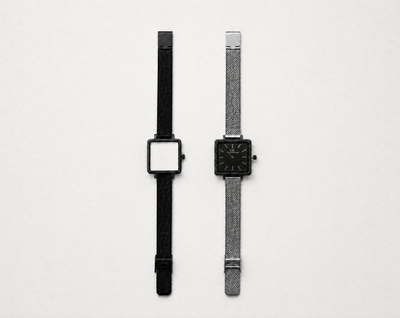 Aureum Swiss Made modular watch — square black case with black mesh strap and square silver case with black dial and silver mesh strap