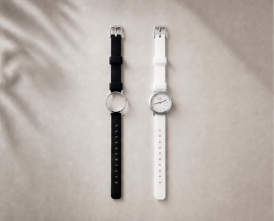 Certamen Swiss Made modular women's sport watch — round silver case with white dial, shown with interchangeable black and white PVC straps