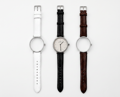 Elegans Swiss Made modular watch — round silver case with interchangeable white, black and brown leather straps