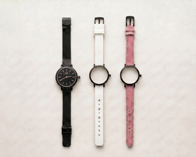 Mixta Swiss Made modular women's watch — round black case with black dial, shown with interchangeable black mesh, white PVC and pink leather straps
