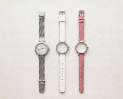 Mixta Swiss Made modular women's watch — round silver case with white dial, shown with interchangeable silver mesh, white PVC and pink leather straps