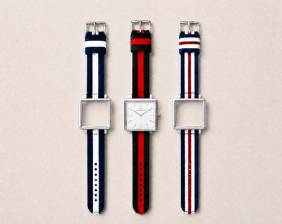 Tela Swiss Made modular watch — square silver case with white dial, shown with three interchangeable nato straps in navy-white, black-red and navy-red-white