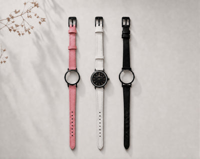 Venustus Swiss Made modular women's watch — round black case with black dial, shown with interchangeable pink, white and black leather straps