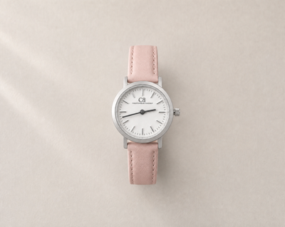 Venustus Swiss Made modular women's watch — round silver case with white dial and pink leather strap, close-up product view