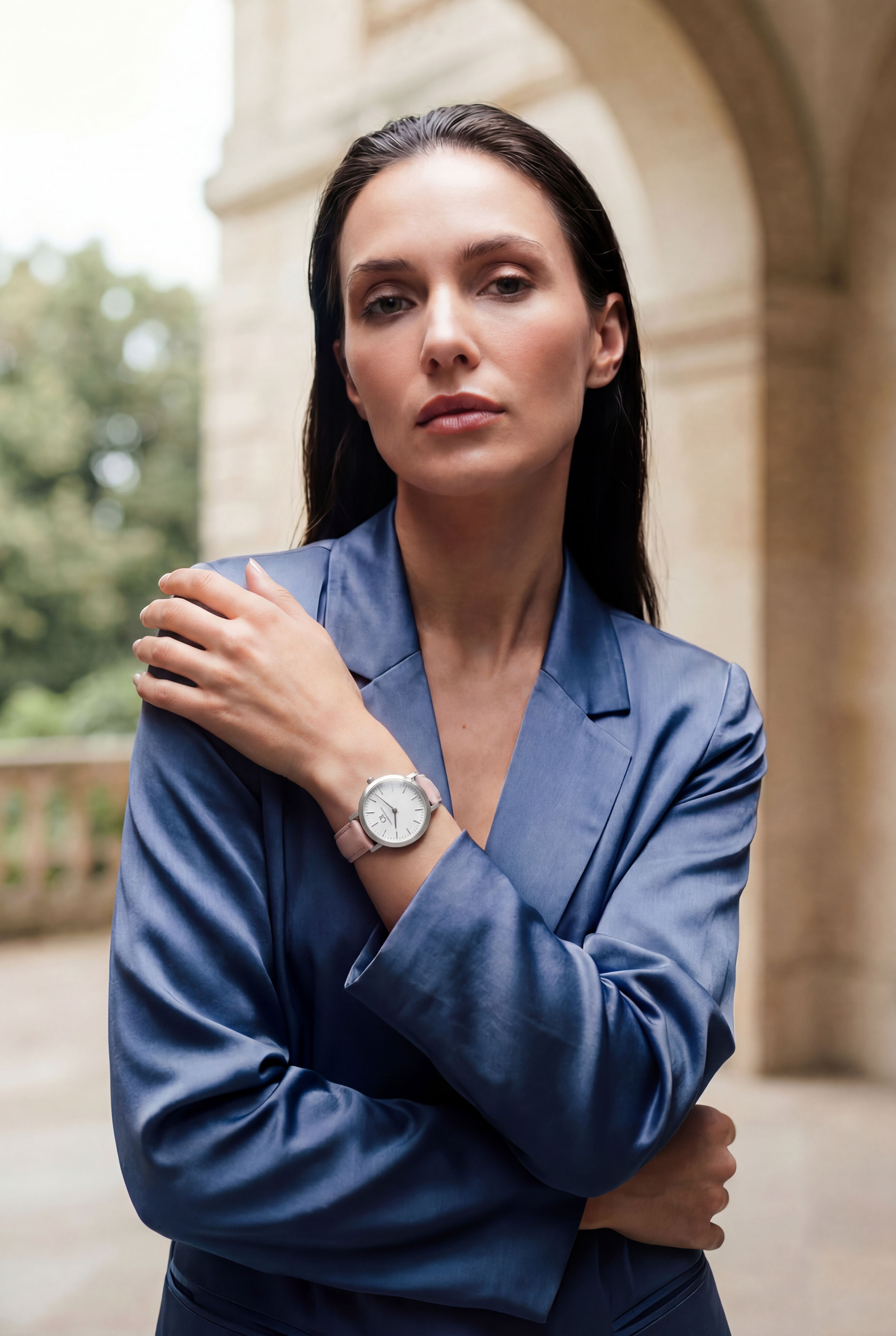 Woman in blue blazer wearing Venustus Swiss Made modular women's watch with round silver case and pink leather strap — Christopher Butendorff